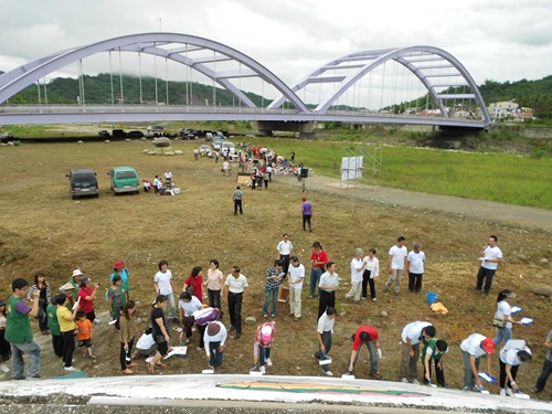 甲仙民間社團共同申請經費，號召甲仙人一同塗刷堤防，展現團結的精神